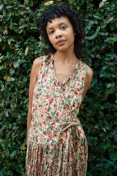 woman standing in garden wearing a floral dress