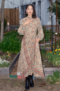 woman in a garden wearing a floral dress