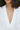 detail of neckline in warm white osnaburg.