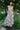 Woman wearing a floral dress standing in a garden