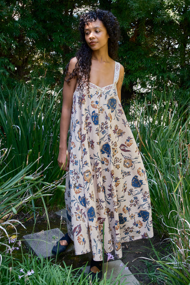 Woman wearing a floral dress standing in a garden