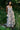 Woman wearing a floral dress standing in a garden