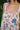 Floral patterned dress with colorful flowers on a blurred natural background
