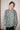Person wearing a patterned shirt against a plain background