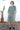 Woman wearing a floral outfit standing outdoors with a cactus plant in the background