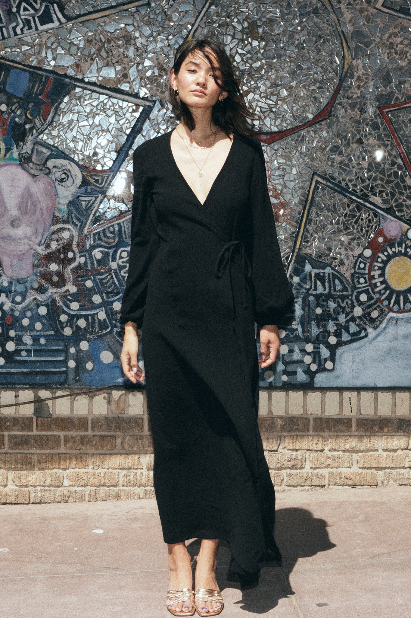 Woman in a black maxi wrap dress