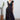 Woman wearing a black dress with a cactus plant in the background