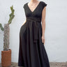 Woman wearing a black dress with a cactus plant in the background