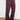 Person wearing black fig flared pants against a white wall.