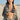 Woman on a beach wearing a patterned jacket and polka dot  bikini top.