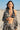 Woman on a beach wearing a patterned jacket and polka dot  bikini top.