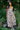 Woman wearing a floral dress standing in a garden