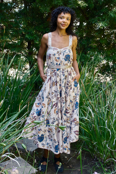 Woman wearing a floral dress standing in a garden