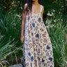 Woman wearing a floral dress standing in a garden