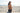Woman in a polka dot bikini sitting on a sandy beach with ocean in the background