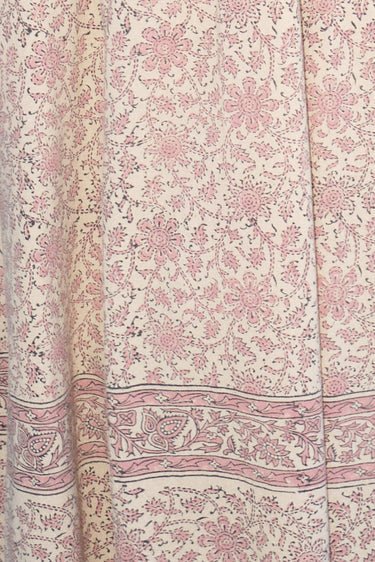 Close-up of a floral patterned fabric with pink and beige colors.