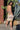 Woman in a patterned short set  standing in front of cacti