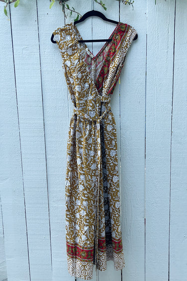 Patterned dress on a hanger against a light blue wooden background