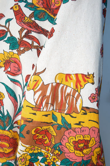 Close-up of a fabric with colorful animal and floral pattern