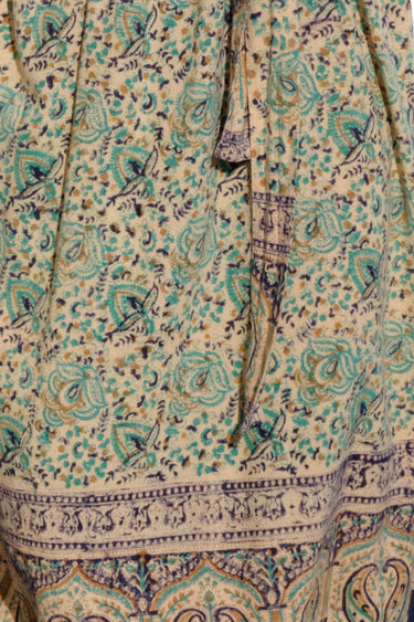 close up of turquoise flower handloom tapestry option for trouser.