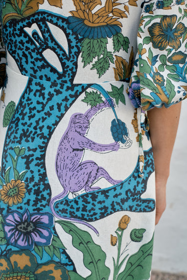 A woman modeling a maxi dress with a tree of life print.