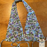 A floral printed bikini top with ties around the neck and back, displayed on a flat surface.