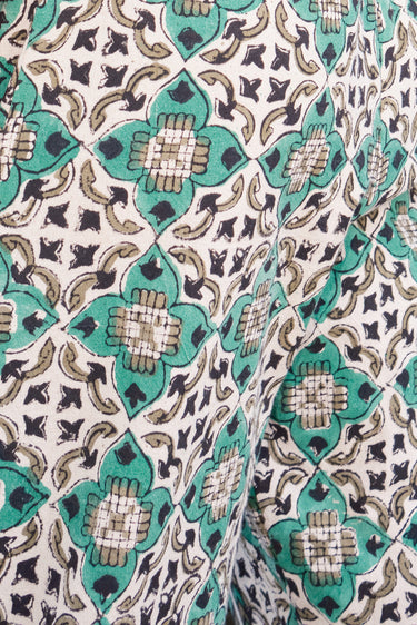 Swatch of verde tile tapestry a green, beige and black fabric.