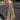 A woman standing on the sidewalk wearing a green floral tapestry midi dress with an elastic neckline and pockets.